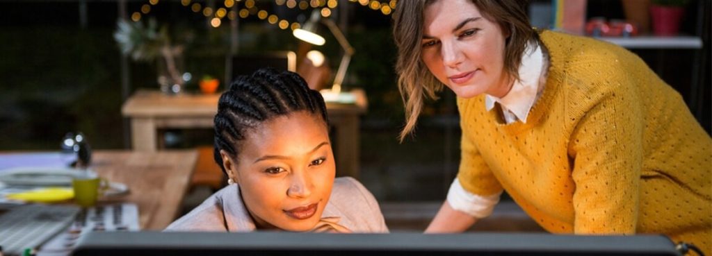 Two women looking at a computer screen