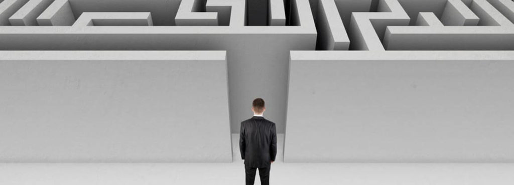 A professional standing in front of a maze