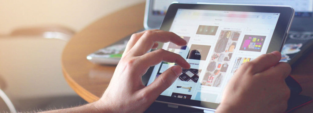 A person is using an iPad on a table